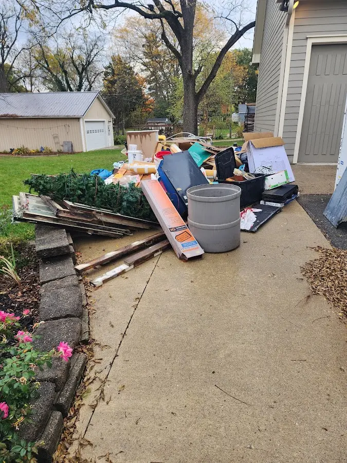 Dumpster being loaded with debris for Residential Dumpster Rental in Malden